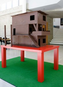Rancho de Chocolate, 2008. (Chocolate Shack) Approx 80 kgs of milk chocolate, Table and Fake grass rug 1,15 x 80 x 90 cms